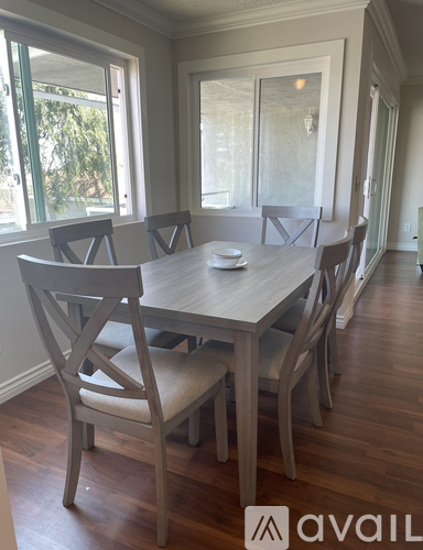 A dining room with a table and chairs.