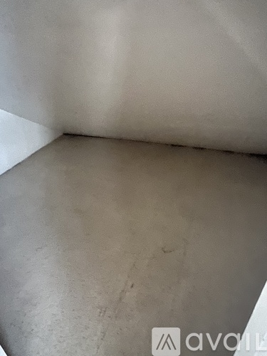 A room with a grey floor and white walls.