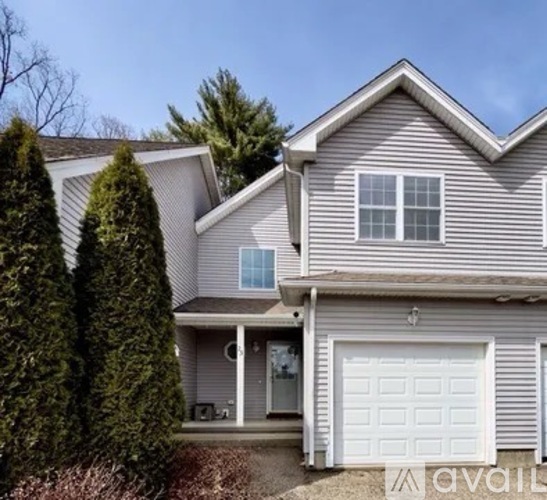 A house with a white garage door is for sale.