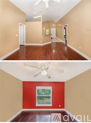 A room with a red wall and a window.