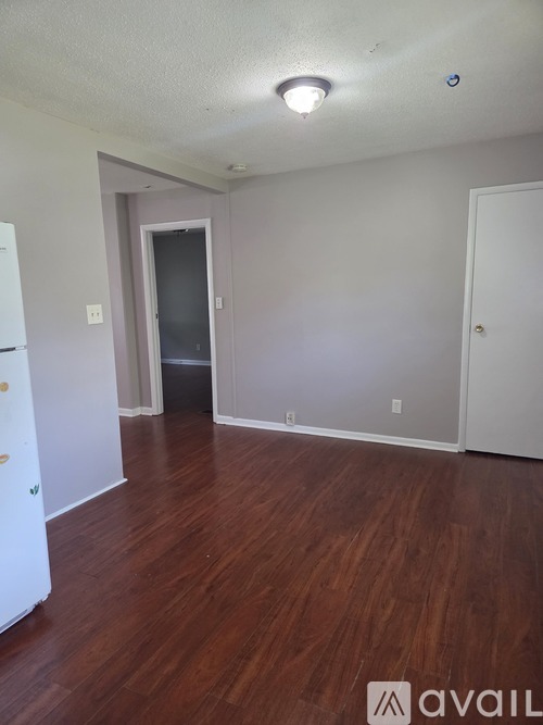 A room with wooden floors and white walls.