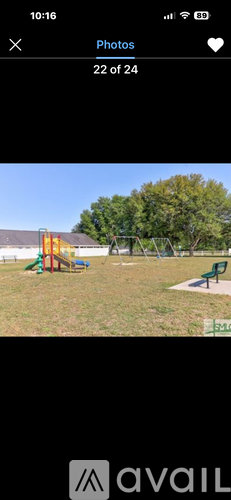 A playground with a green slide and a red and yellow structure.