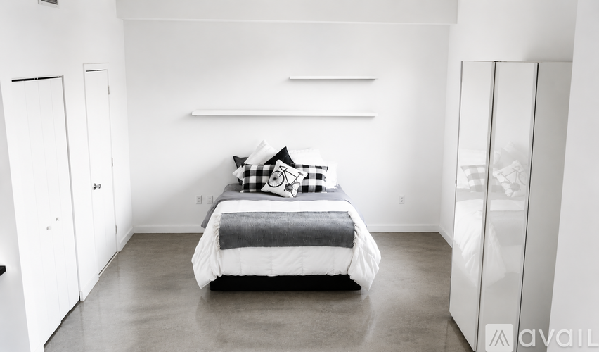 A bedroom with a bed in the middle of the room.