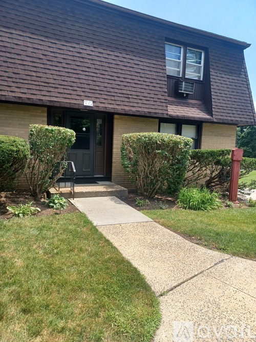 A house with a brown roof and a black door.