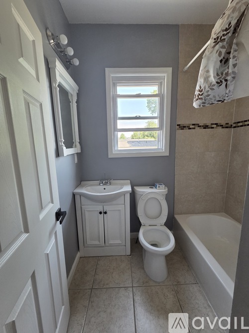 A small bathroom with a toilet, sink, and tub.