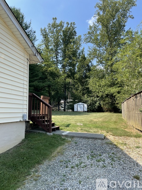 A house with a gravel path leading to a wooden deck.