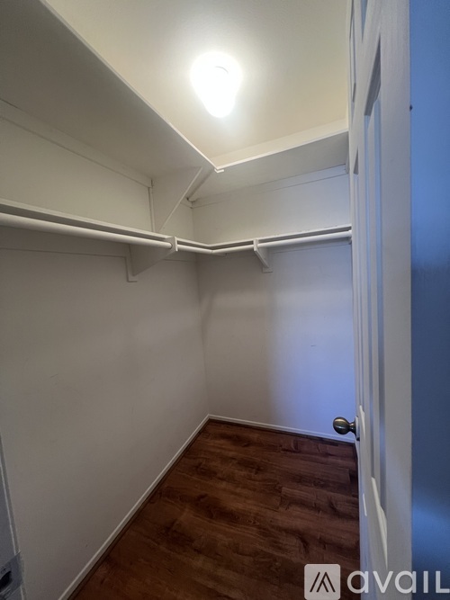 A room with a white door and a light on the ceiling.