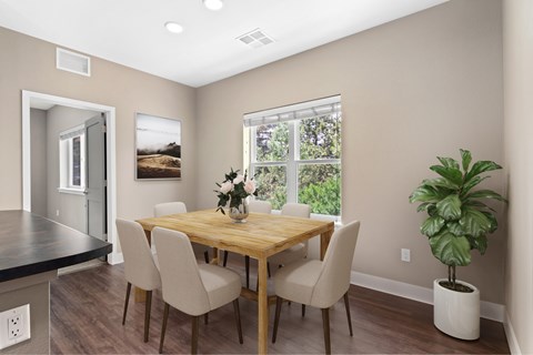 A dining room with a wooden table and chairs.
