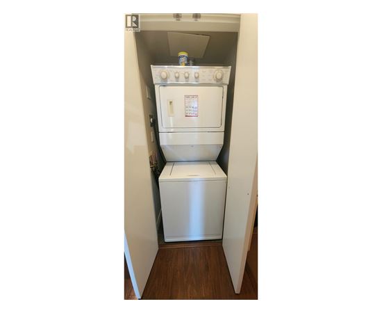 A white oven and microwave are installed in a small kitchen.