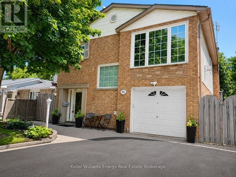 A house with a white garage door and a brick exterior is for sale.