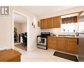 A kitchen with wooden cabinets and a black stove top oven.