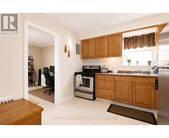 A kitchen with wooden cabinets and a black stove top oven.
