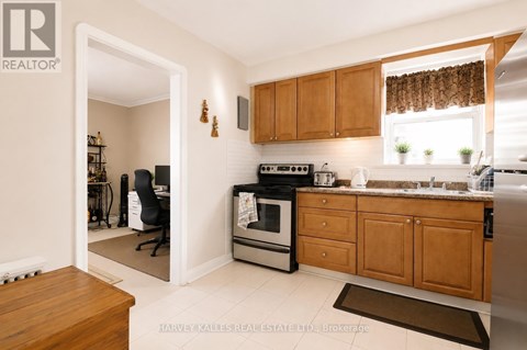 A kitchen with wooden cabinets and a black stove top oven.