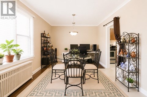 A dining room with a table set for four.
