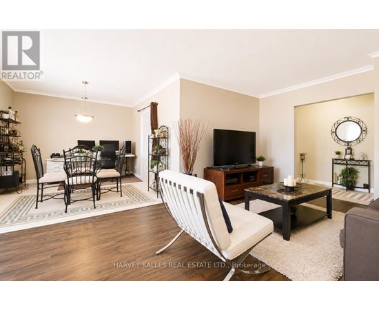 A living room with a white chair in the foreground.