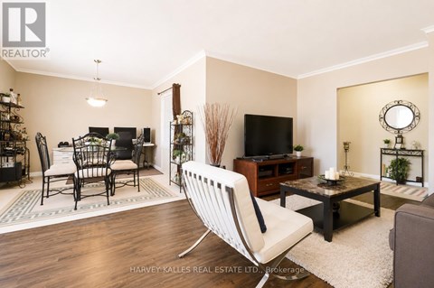 A living room with a white chair in the foreground.