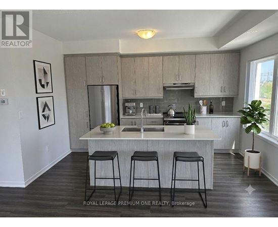 A kitchen with a bar stool in front of it.