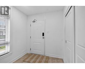 A white door with a window to the left and a wall to the right.