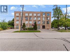 A large brick building with a parking lot in front.