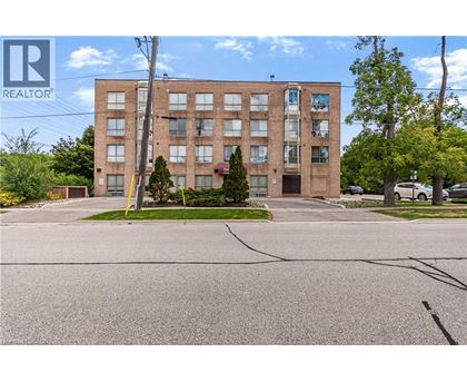 A large brick building with a parking lot in front.