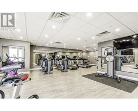A gym with a variety of equipment including treadmills, stationary bikes, and weight machines.