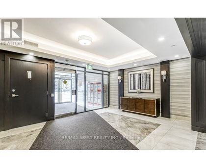 A hallway with a black door and a wooden bench.