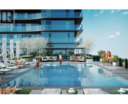 A group of people are enjoying the sun by a pool in front of a modern building.