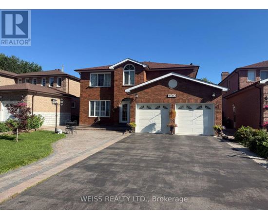 A house with a driveway in front of it.