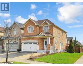A large brick house with a white garage door is for sale.