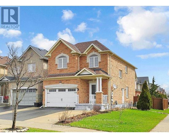 A large brick house with a white garage door is for sale.
