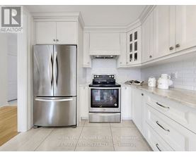 A kitchen with a stainless steel refrigerator and oven.