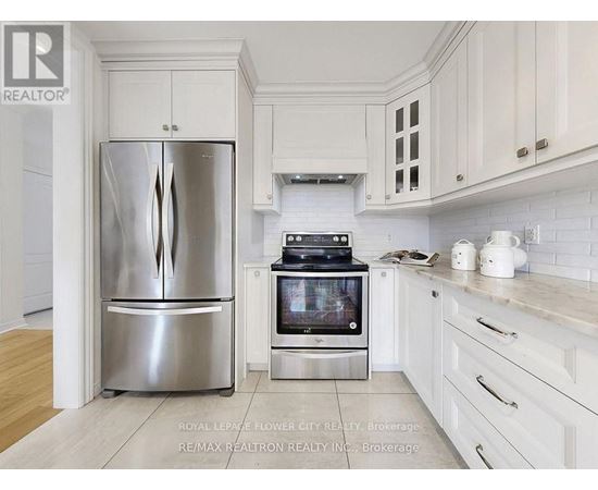 A kitchen with a stainless steel refrigerator and oven.