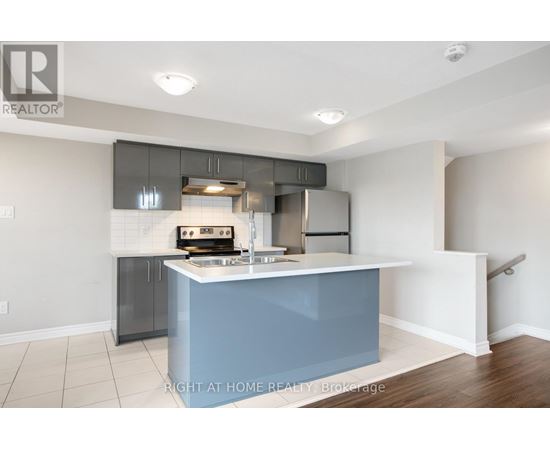 A kitchen with a blue island and stainless steel appliances.