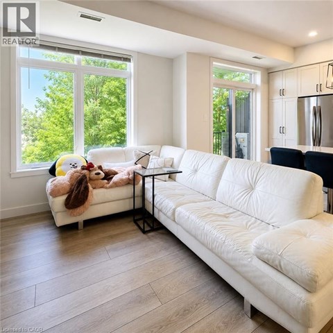 A white couch with a stuffed animal on it in a living room.