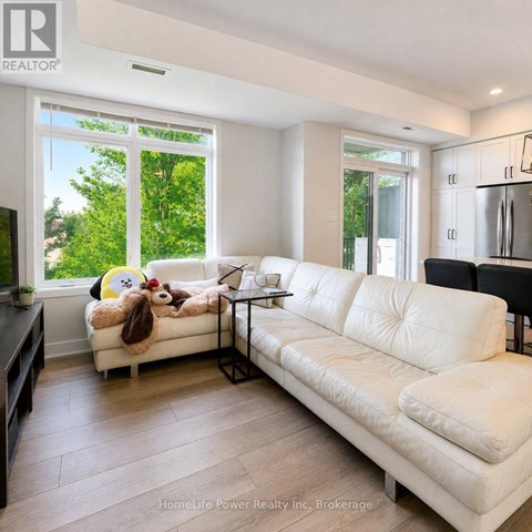 A white couch with a stuffed animal on it in a living room.