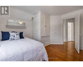 A bedroom with a bed, a dresser, and a mirror.