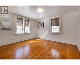 A room with wooden floors and white walls.