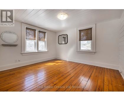 A room with wooden floors and white walls.