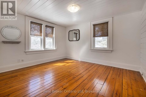 A room with wooden floors and white walls.