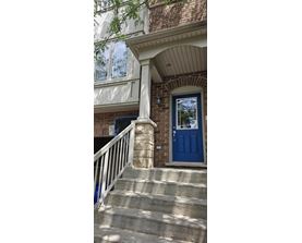 A blue door is on the right side of a white railing.