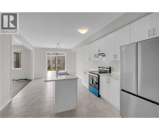 A modern kitchen with white cabinets and a central island.