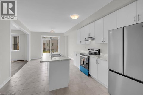 A modern kitchen with white cabinets and a central island.