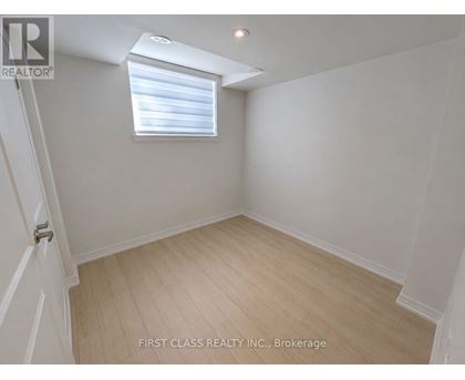 A room with a window and wooden flooring.