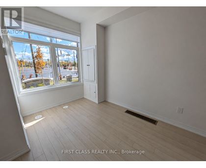 A room with a large window and a door is for sale.