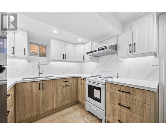A modern kitchen with wooden cabinets and stainless steel appliances.