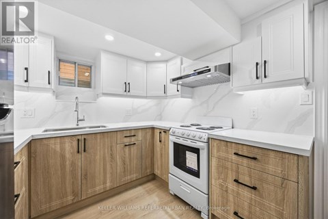 A modern kitchen with wooden cabinets and stainless steel appliances.