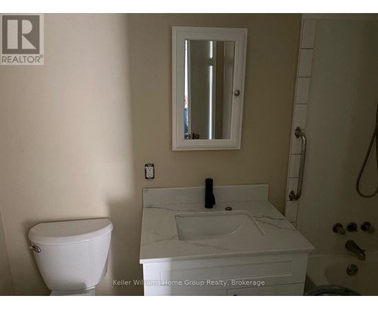A white toilet sits next to a sink in a bathroom.
