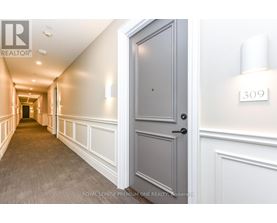 A hallway with a door on the right and a number 309 on the wall.