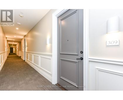 A hallway with a door on the right and a number 309 on the wall.