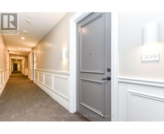 A hallway with a door on the right and a number 309 on the wall.